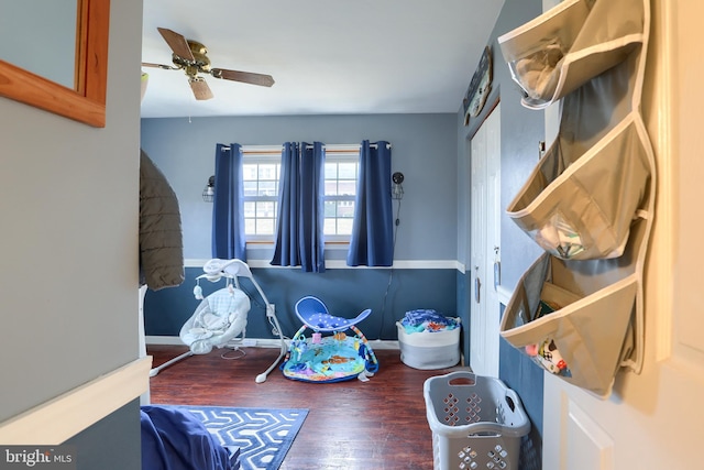 interior space featuring baseboards, wood finished floors, and ceiling fan