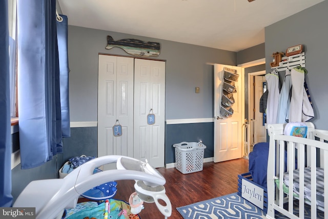 bedroom featuring a closet, baseboards, and wood finished floors