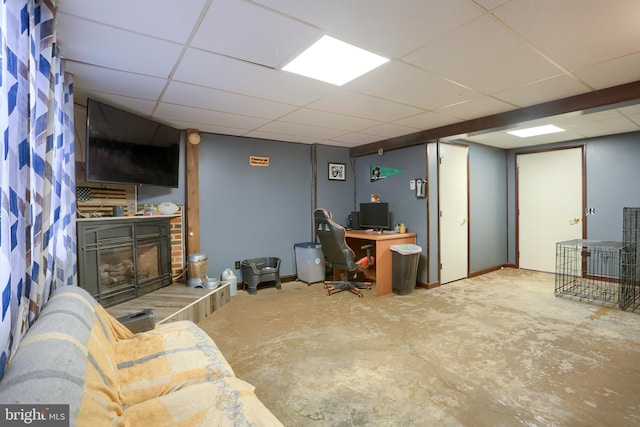 office space with a paneled ceiling and concrete floors