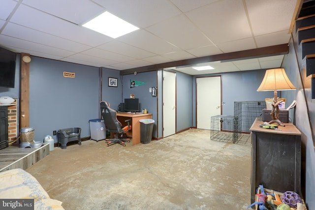 office space featuring a drop ceiling and unfinished concrete flooring