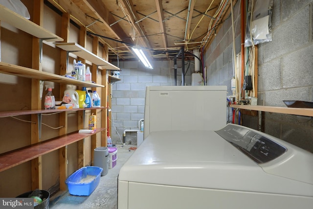 clothes washing area featuring washing machine and clothes dryer and laundry area