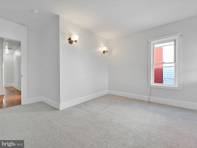 empty room with carpet and baseboards