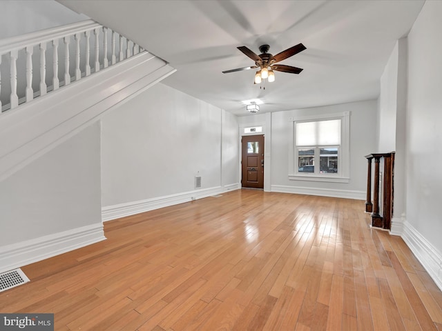 unfurnished living room featuring baseboards, visible vents, and light wood-type flooring