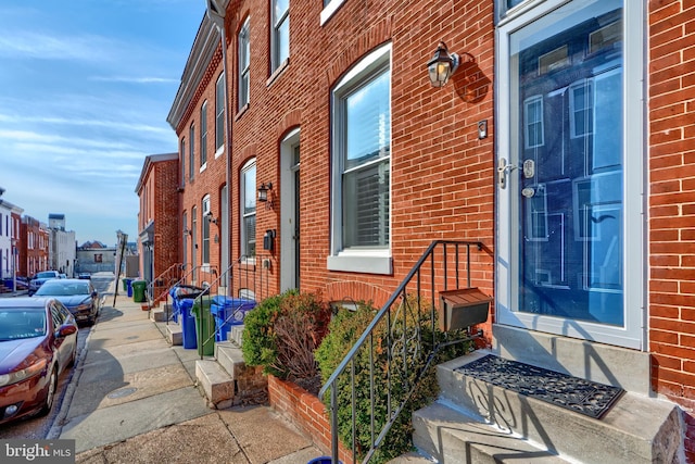 entrance to property with brick siding