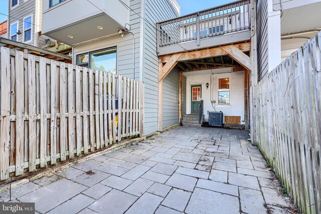 view of patio featuring cooling unit and fence