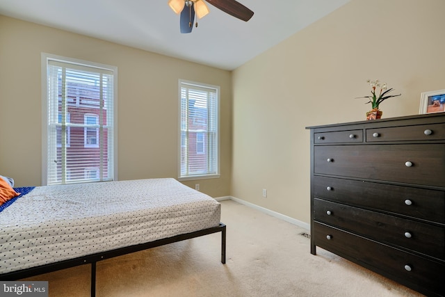 bedroom with baseboards, light colored carpet, and a ceiling fan