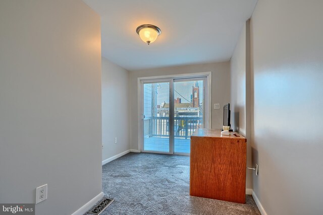 interior space with baseboards, carpet floors, and visible vents