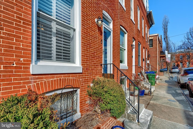 view of property exterior with brick siding