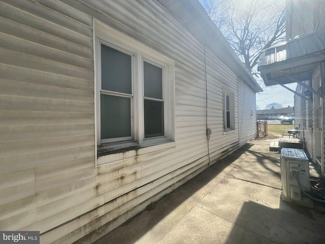 view of property exterior featuring a patio and ac unit