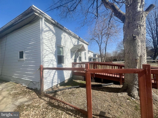 view of property exterior with a wooden deck