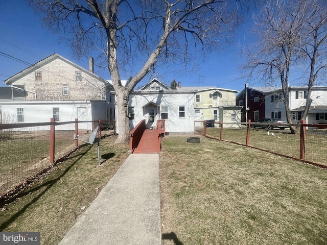 rear view of property with a yard, a residential view, and fence