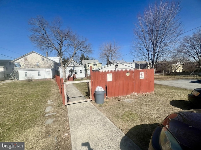 view of property exterior with a yard and fence