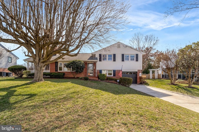 tri-level home featuring brick siding, concrete driveway, a garage, and a front yard