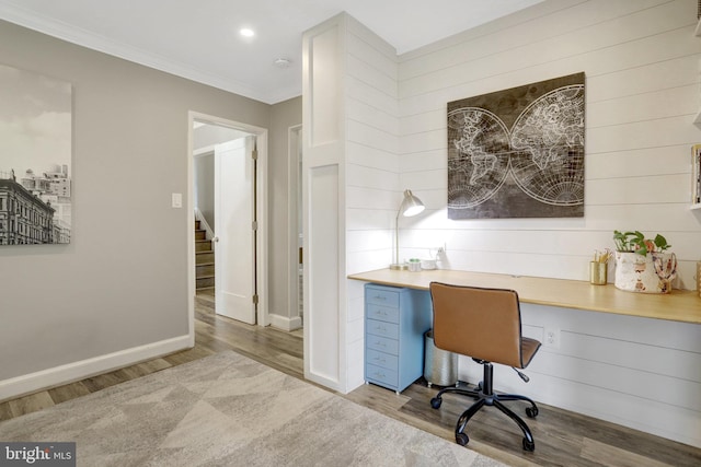 office space featuring recessed lighting, baseboards, wood finished floors, and ornamental molding