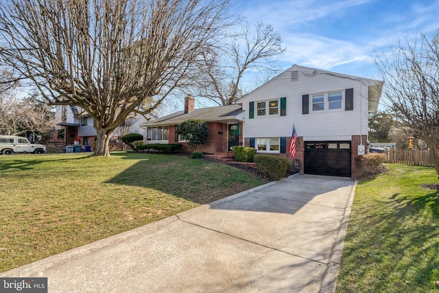 tri-level home with brick siding, a front lawn, fence, concrete driveway, and a chimney