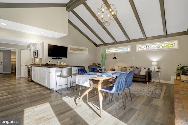 dining room with baseboards, beam ceiling, wood finished floors, a notable chandelier, and high vaulted ceiling