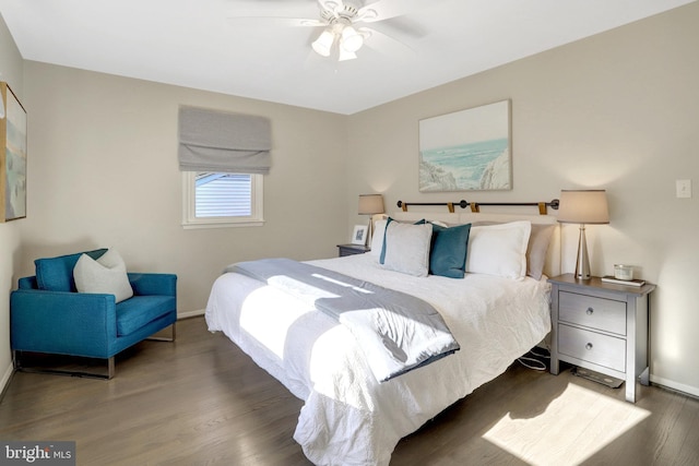 bedroom with ceiling fan, baseboards, and wood finished floors