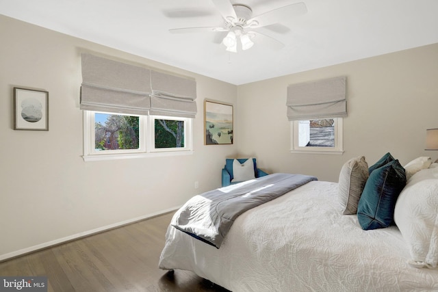 bedroom with wood finished floors, baseboards, and ceiling fan