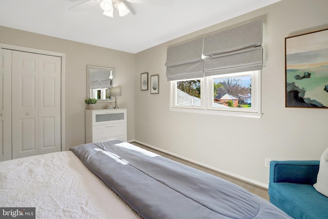 bedroom with a closet, ceiling fan, and baseboards