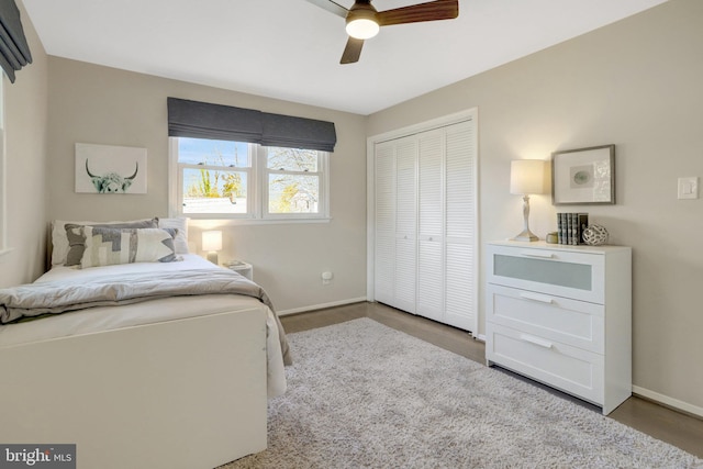 bedroom featuring a closet, baseboards, and a ceiling fan