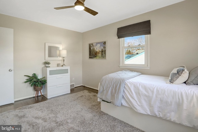 bedroom featuring wood finished floors, baseboards, and ceiling fan