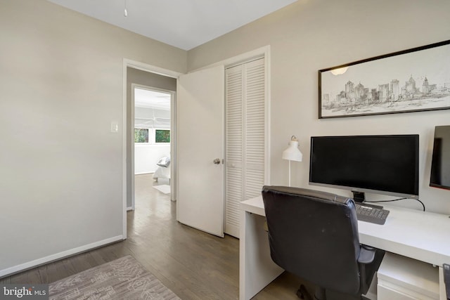 home office featuring wood finished floors and baseboards