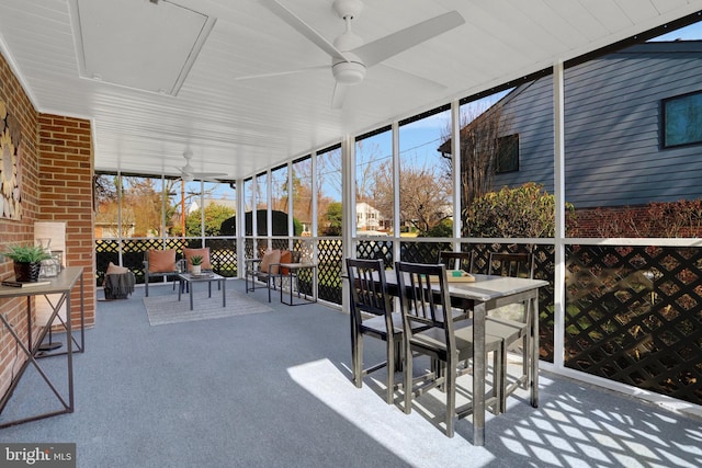 sunroom / solarium with plenty of natural light and a ceiling fan