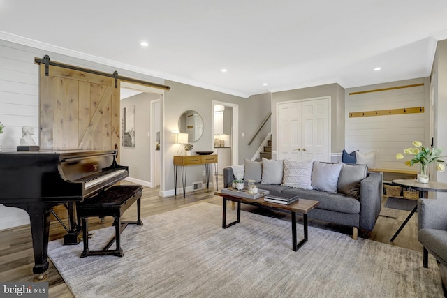 living area featuring baseboards, stairs, ornamental molding, recessed lighting, and light wood-style flooring