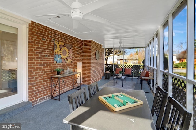 sunroom / solarium featuring ceiling fan