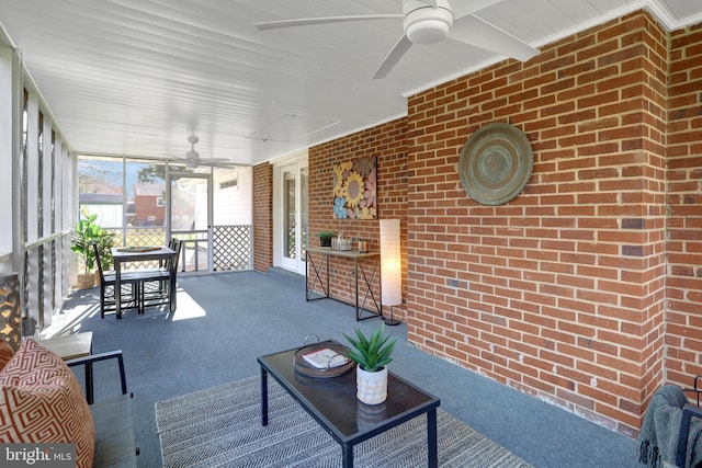 sunroom featuring a ceiling fan