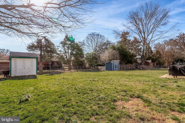 view of yard featuring an outbuilding, a storage unit, and a fenced backyard