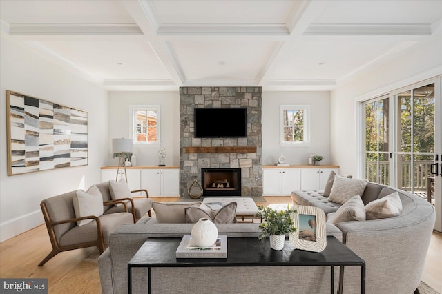 living room featuring coffered ceiling, a healthy amount of sunlight, wood finished floors, and a fireplace