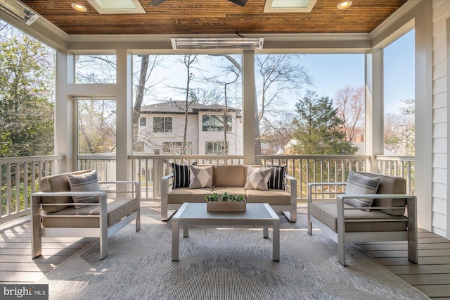 sunroom / solarium with a skylight, wood ceiling, and a wealth of natural light