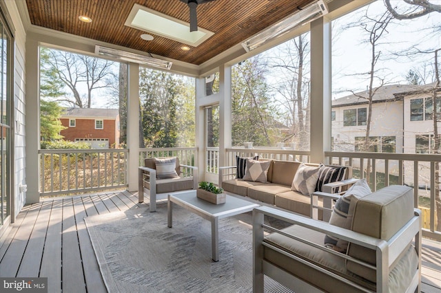 sunroom / solarium featuring wooden ceiling and a skylight