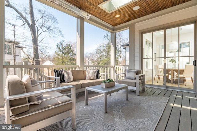 sunroom with a skylight and wood ceiling