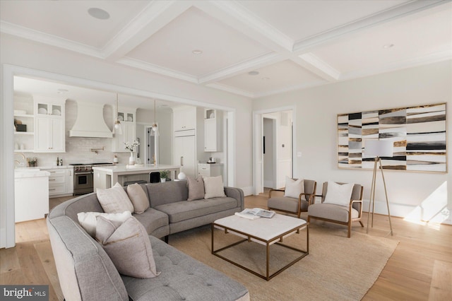 living area featuring light wood-style floors, beam ceiling, coffered ceiling, and ornamental molding