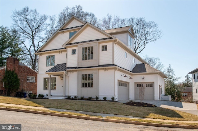 view of front of house with brick siding, a front lawn, metal roof, driveway, and a standing seam roof