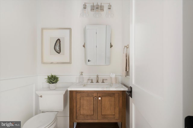 half bath featuring toilet and vanity