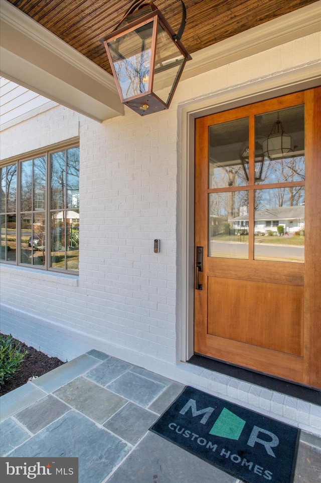 entrance to property with brick siding