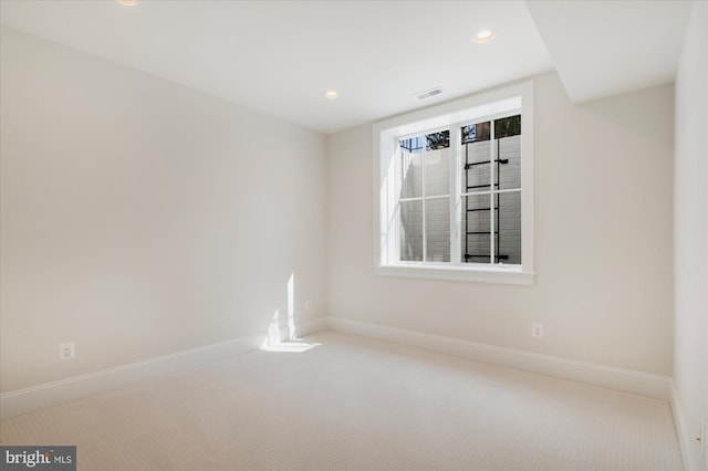 spare room featuring visible vents, recessed lighting, carpet, and baseboards