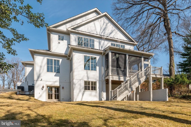 back of house with french doors, stairs, a yard, and a sunroom