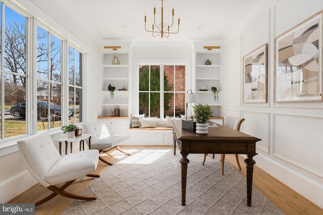 sunroom / solarium featuring a chandelier