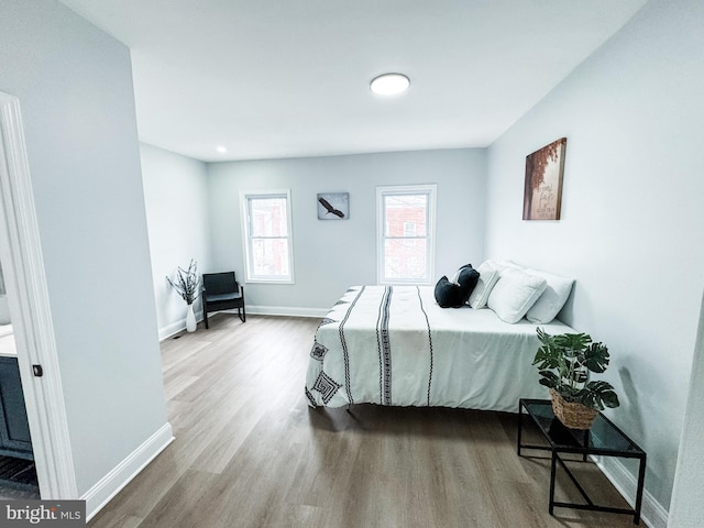 bedroom featuring baseboards and wood finished floors