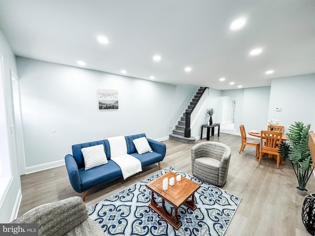 living area with light wood finished floors, stairway, recessed lighting, and baseboards