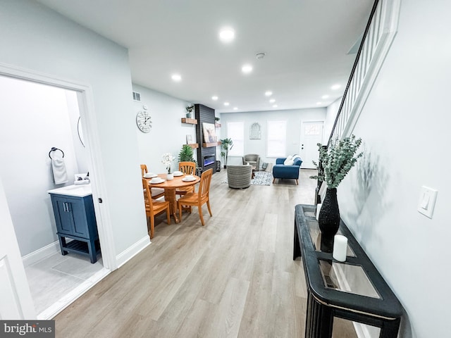 interior space with light wood-style flooring, recessed lighting, visible vents, and baseboards