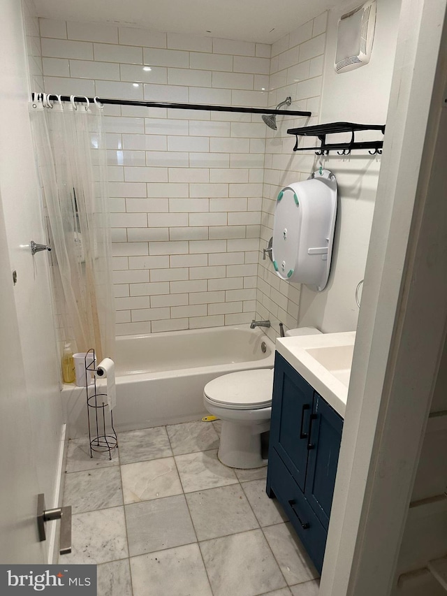 bathroom featuring toilet, shower / bath combo with shower curtain, and vanity