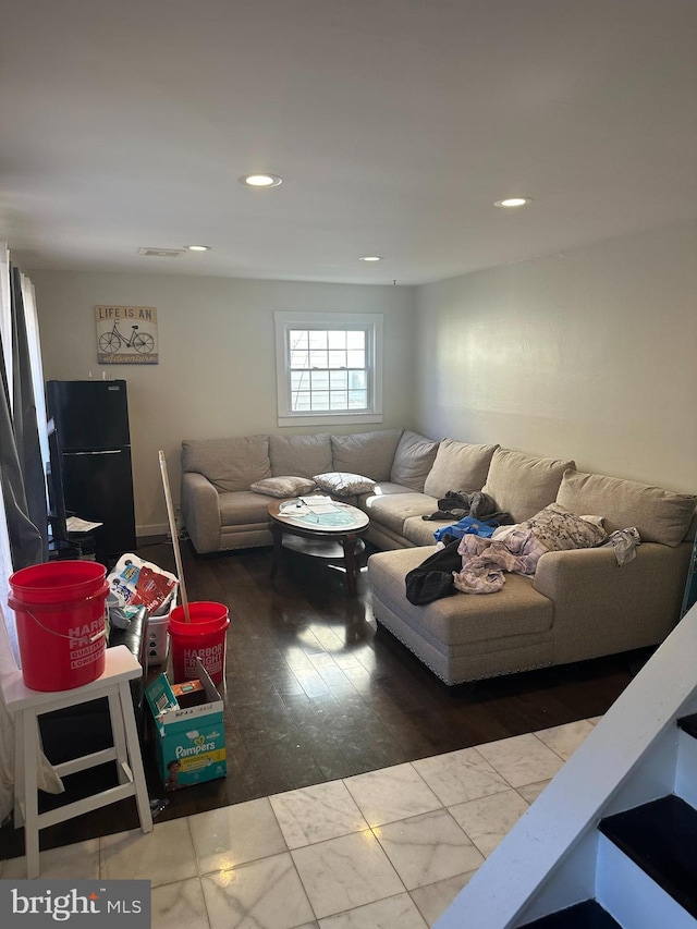 living area featuring recessed lighting and visible vents