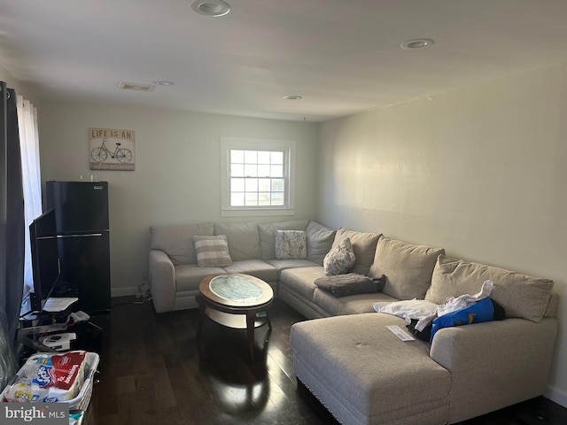 living room featuring dark wood-style floors and visible vents