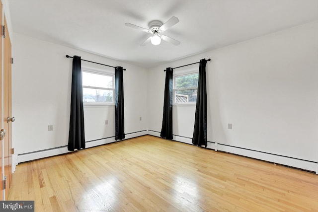 spare room with light wood-type flooring and a ceiling fan