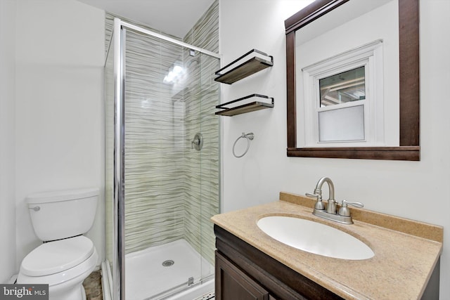 full bath with toilet, a stall shower, and vanity